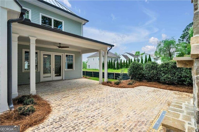 view of patio with a ceiling fan, french doors, and fence