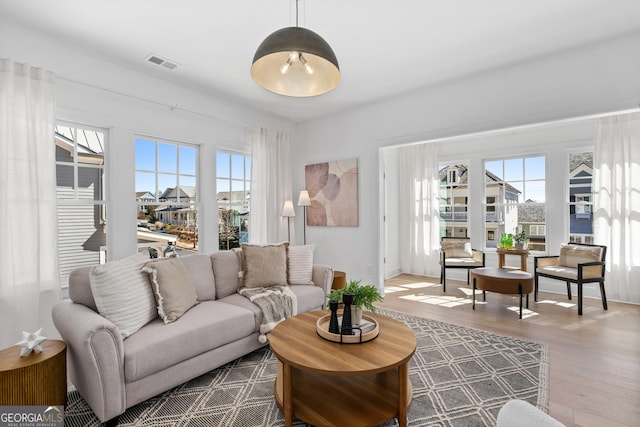 living room with wood finished floors and visible vents