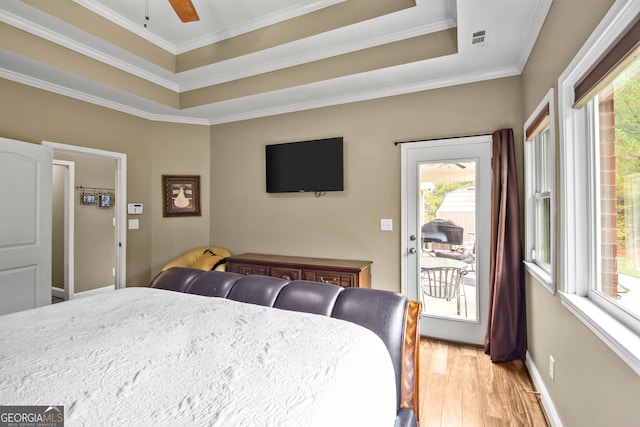 bedroom with light hardwood / wood-style floors, ceiling fan, ornamental molding, and access to outside