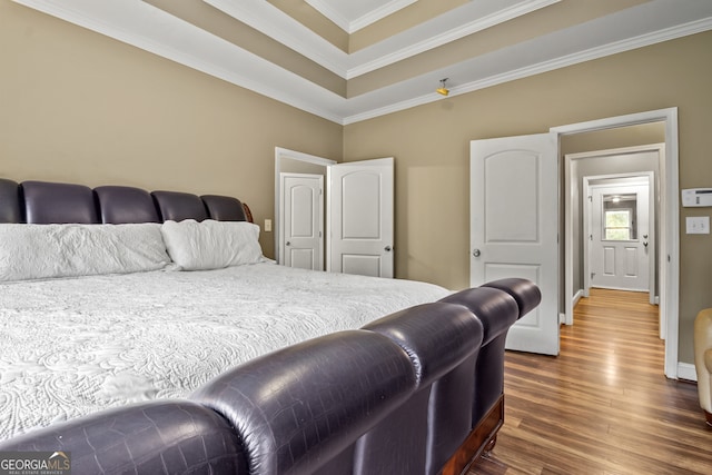 bedroom with dark wood-type flooring and ornamental molding