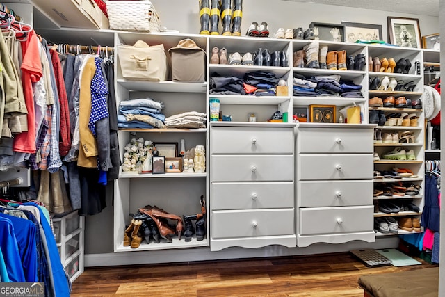 spacious closet featuring hardwood / wood-style flooring