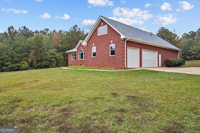 view of side of property with a garage and a lawn