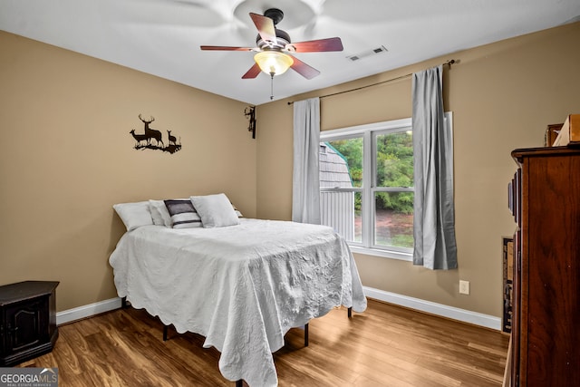 bedroom featuring hardwood / wood-style floors and ceiling fan