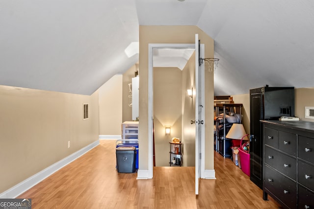 bonus room featuring hardwood / wood-style floors and vaulted ceiling