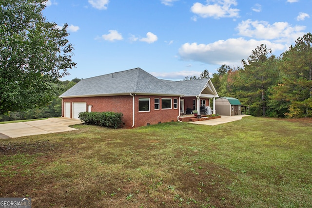 view of front of property with a garage, a front lawn, and a storage unit