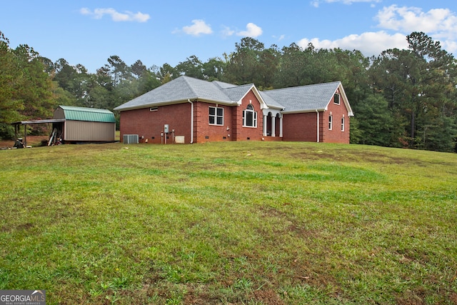 view of front facade with cooling unit, a front lawn, and a storage unit