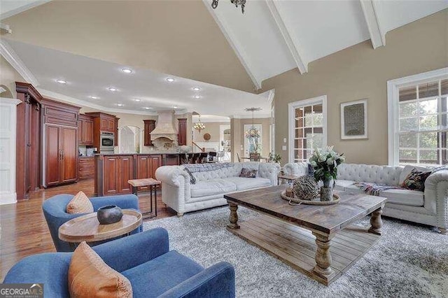 living room featuring beam ceiling, hardwood / wood-style floors, and high vaulted ceiling