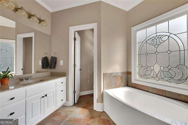 bathroom featuring vanity, a bathtub, and crown molding