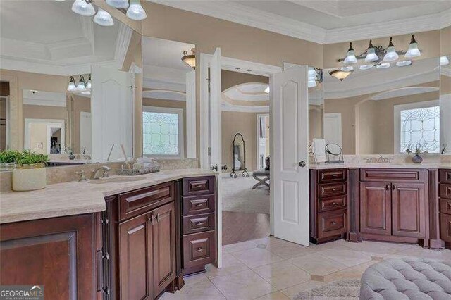 bathroom with vanity, crown molding, tile patterned flooring, and plenty of natural light