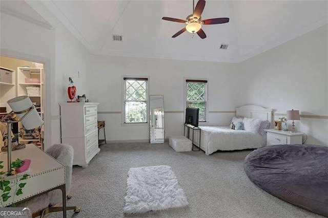 carpeted bedroom with lofted ceiling, ornamental molding, and ceiling fan