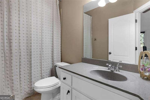 bathroom with vanity, a shower with curtain, and toilet