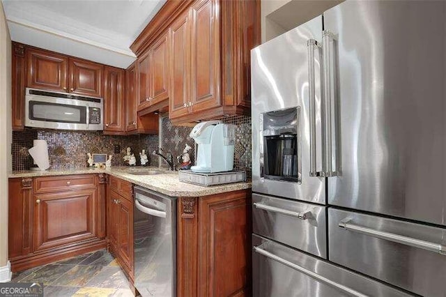 kitchen with crown molding, light stone countertops, stainless steel appliances, and sink