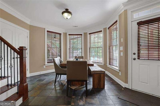 dining area featuring crown molding