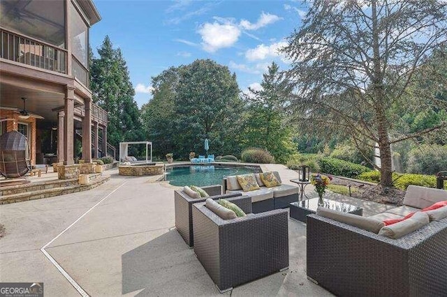 view of patio with ceiling fan, a balcony, and an outdoor hangout area