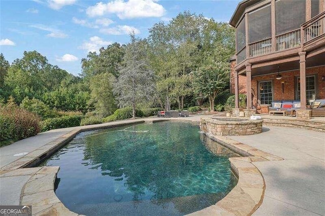 view of pool with an outdoor hangout area, a patio area, and ceiling fan