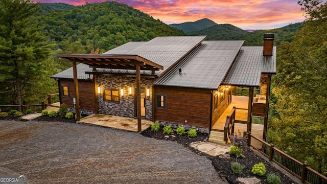 view of front of house with a patio area and a mountain view