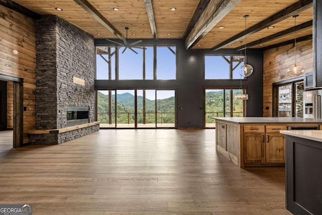 interior space with a mountain view, wooden ceiling, a high ceiling, and dark hardwood / wood-style floors