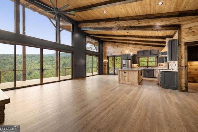 kitchen featuring wood ceiling, hardwood / wood-style floors, ceiling fan, beam ceiling, and stainless steel fridge with ice dispenser