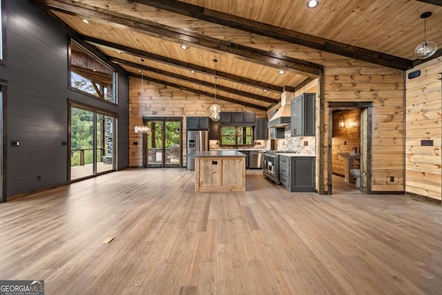 kitchen with gray cabinets, hanging light fixtures, hardwood / wood-style flooring, and stainless steel appliances