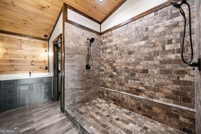 bathroom featuring vanity, wooden ceiling, lofted ceiling, and tiled shower