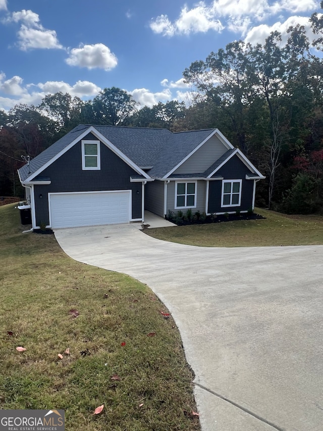 single story home with a garage and a front lawn