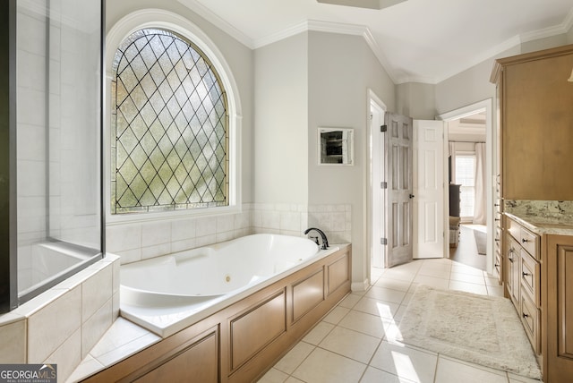 bathroom featuring tiled bath, tile patterned flooring, vanity, and ornamental molding