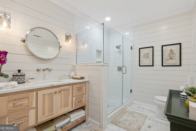 bathroom with an enclosed shower, vanity, toilet, and wooden walls