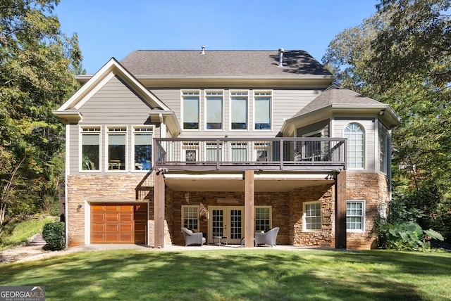 back of house with a yard, french doors, and a garage