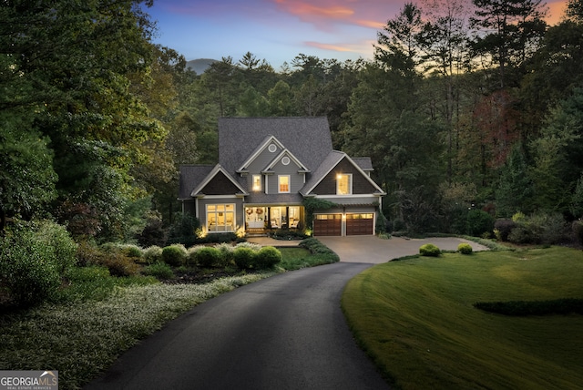 view of front facade with a yard and a garage