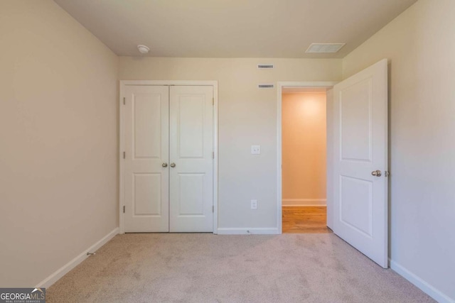 134 Henley St W Unit 09, Canton, GA 30114 - unfurnished bedroom featuring carpet, baseboards, and a closet