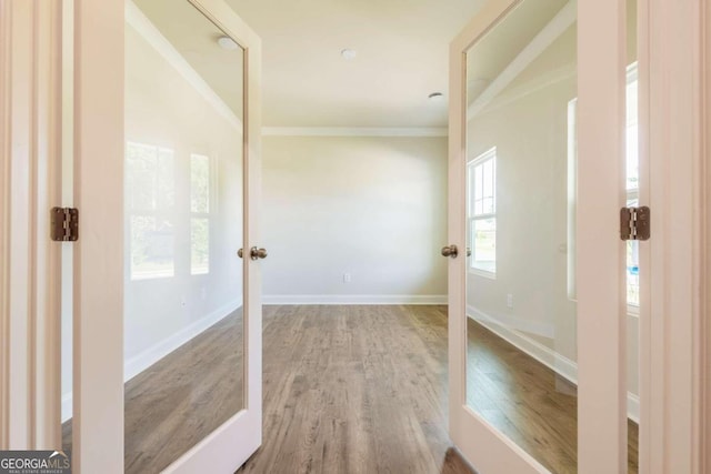 134 Henley St W Unit 09, Canton, GA 30114 - hallway featuring wood finished floors, ornamental molding, baseboards, and french doors