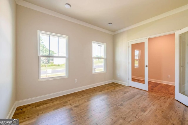 134 Henley St W Unit 09, Canton, GA 30114 - empty room featuring french doors, light wood-style flooring, baseboards, and ornamental molding