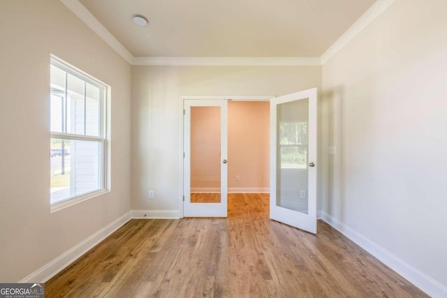 134 Henley St W Unit 09, Canton, GA 30114 - unfurnished room featuring french doors, crown molding, wood finished floors, and baseboards