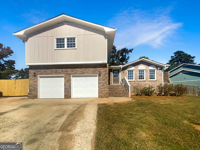 view of front of house featuring a garage and a front lawn