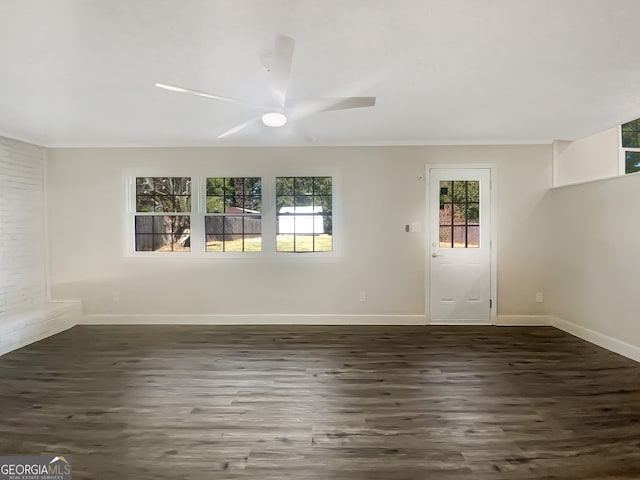 unfurnished room featuring ceiling fan and dark hardwood / wood-style floors