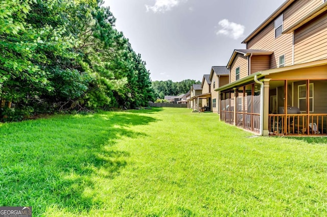 view of yard featuring a sunroom