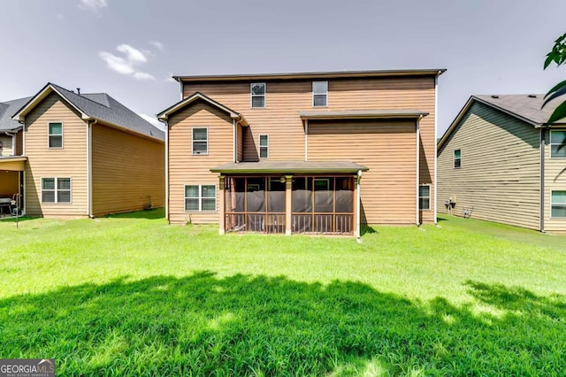 back of property featuring a yard and a sunroom