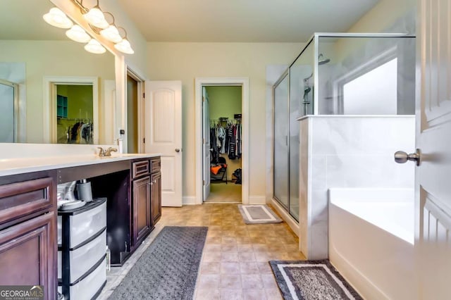 bathroom featuring vanity and shower with separate bathtub