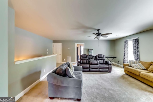 living room featuring ceiling fan and light colored carpet