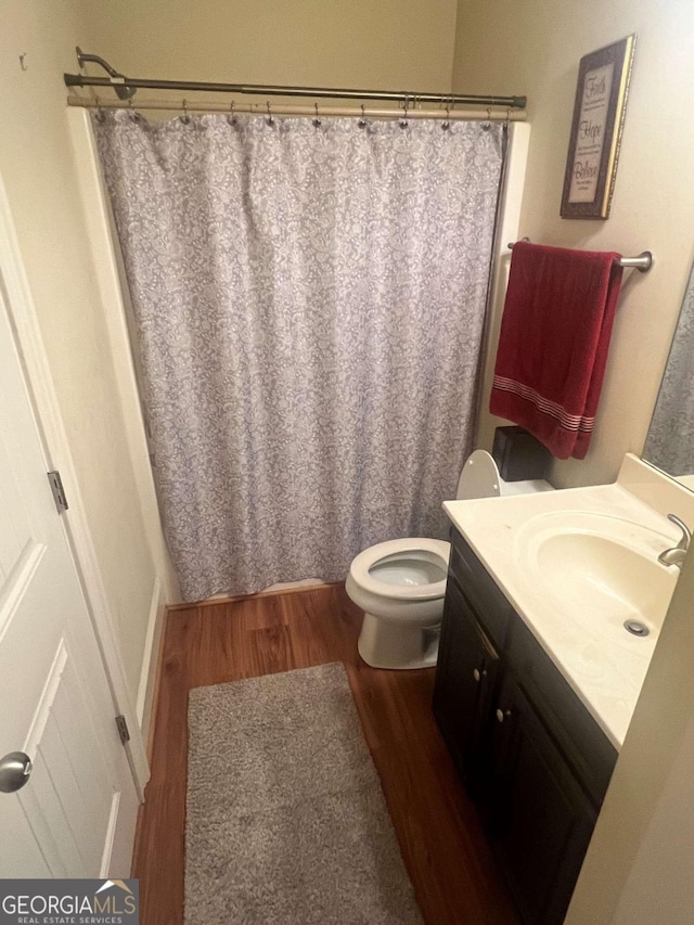 bathroom featuring vanity, a shower with curtain, toilet, and wood-type flooring