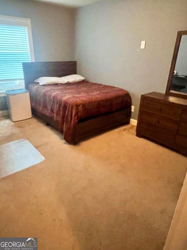 bedroom with light colored carpet