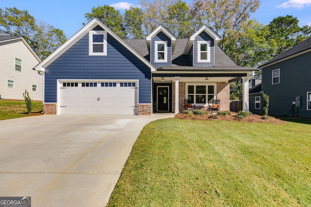 view of front facade with a front yard, covered porch, and a garage