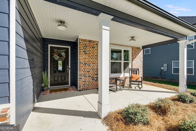 view of exterior entry with a porch