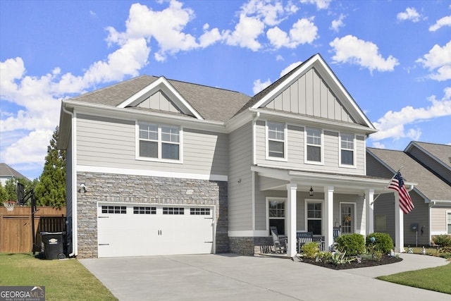 craftsman-style house with a porch, a front yard, and a garage