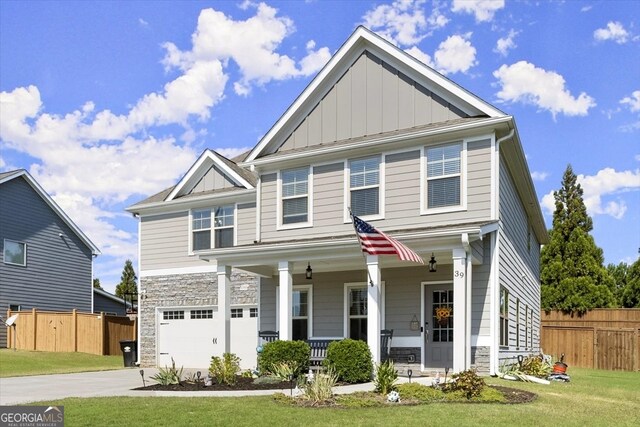 craftsman-style home featuring a porch, a front lawn, and a garage