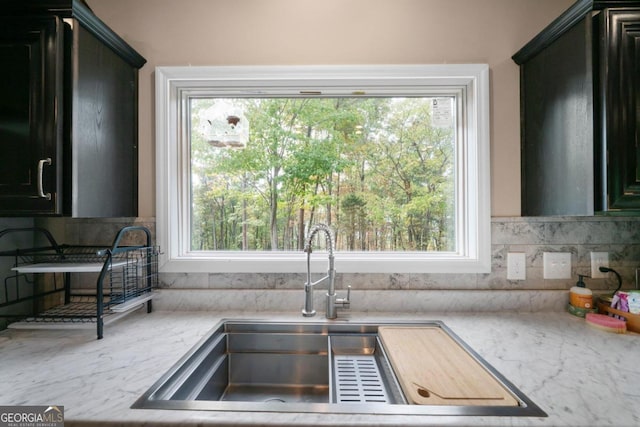 kitchen with decorative backsplash, sink, and plenty of natural light