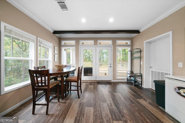 dining area with dark wood-type flooring, crown molding, and a wealth of natural light