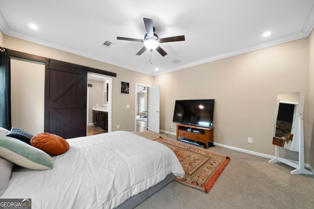 carpeted bedroom with crown molding, a barn door, ensuite bathroom, and ceiling fan