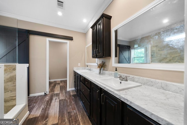 bathroom with vanity, hardwood / wood-style flooring, and ornamental molding