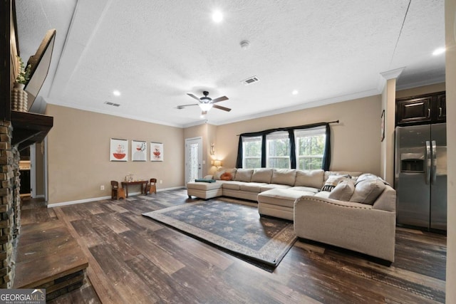 living room featuring dark wood-type flooring, crown molding, and a textured ceiling